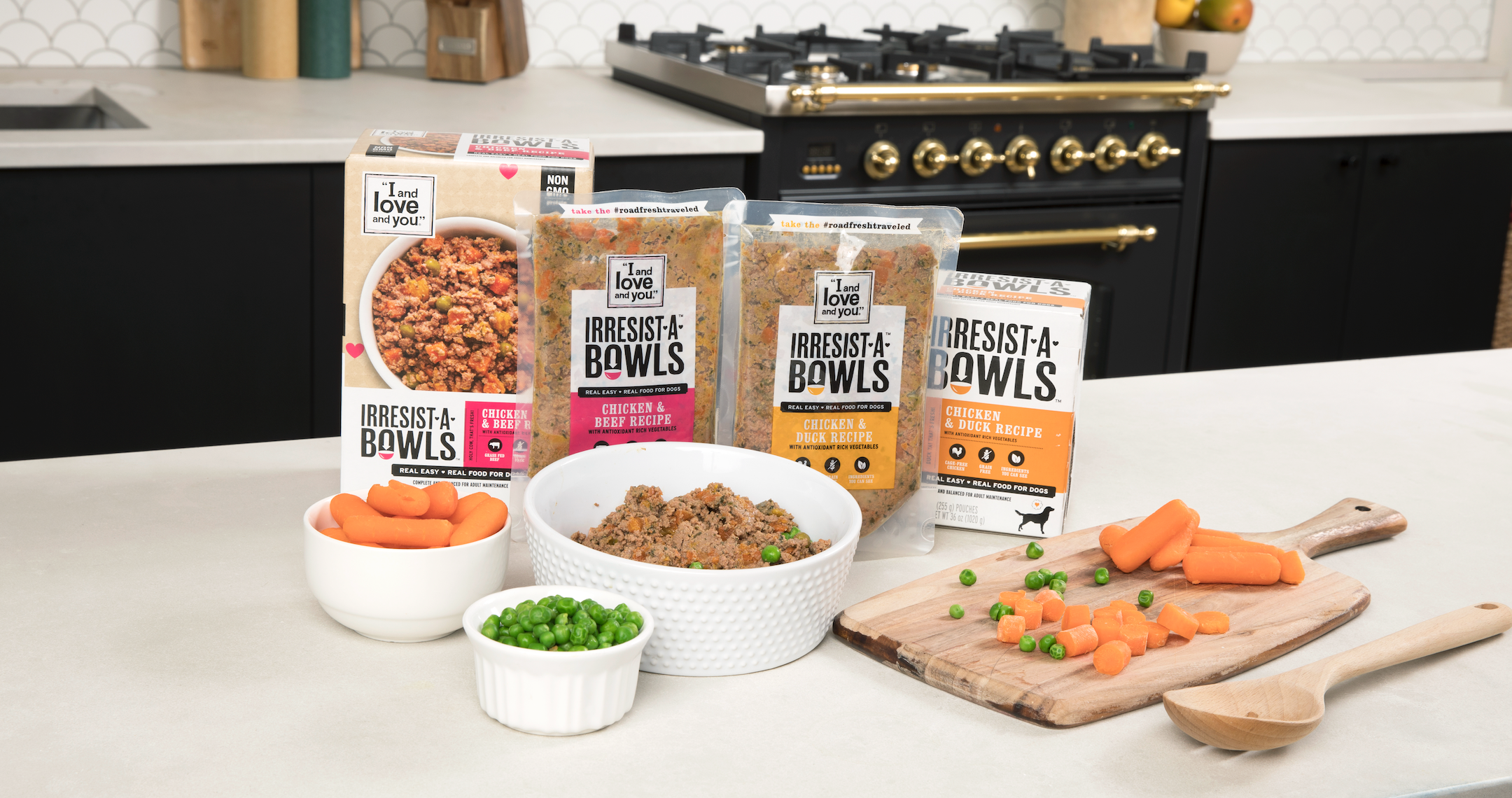 A group of food packages on a counter with bowls of peas, carrots, and green peppers, a wooden spoon, and a cutting board.