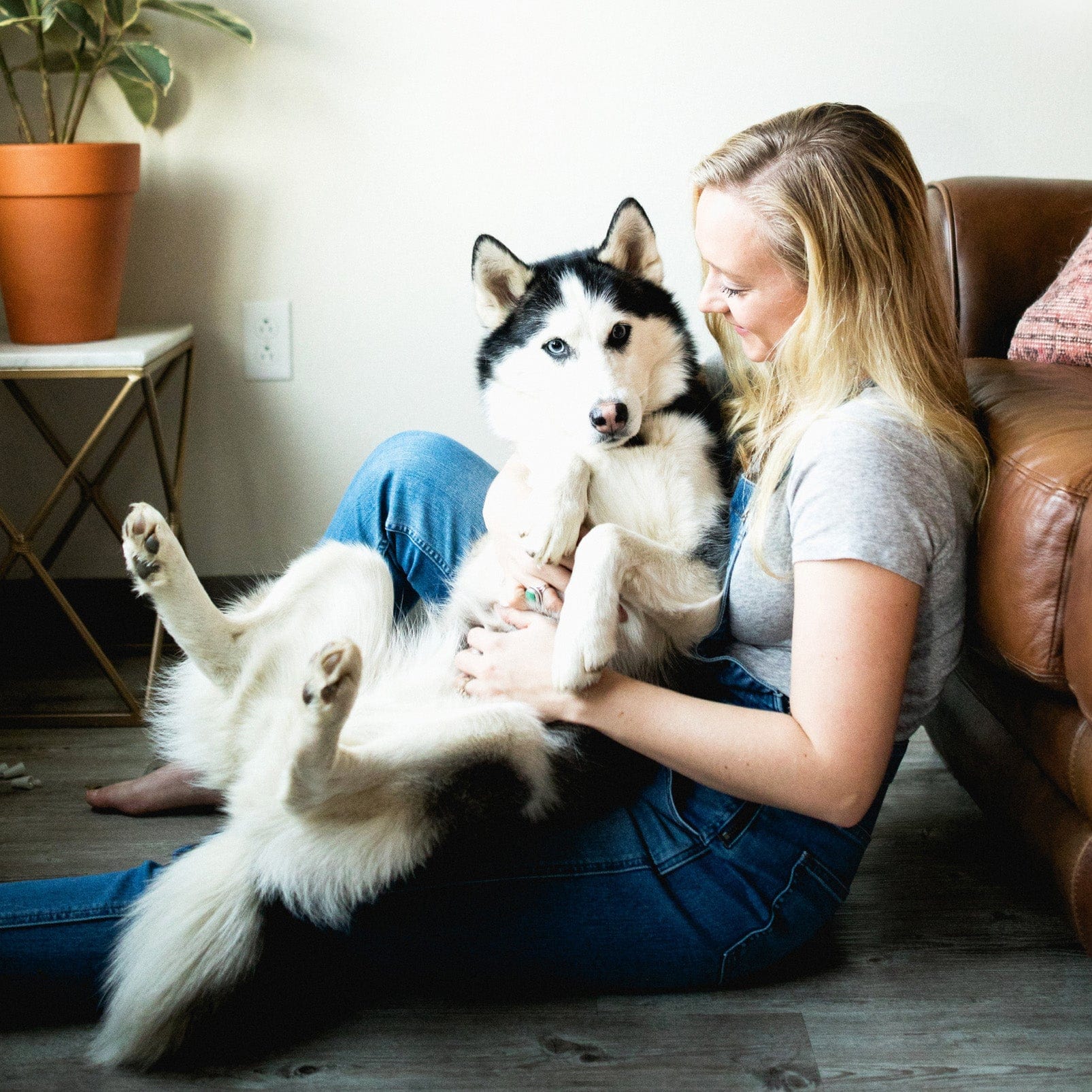 happy girl on the floor holding a dog