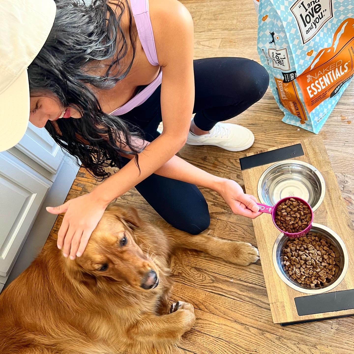 A woman feeding a dog.